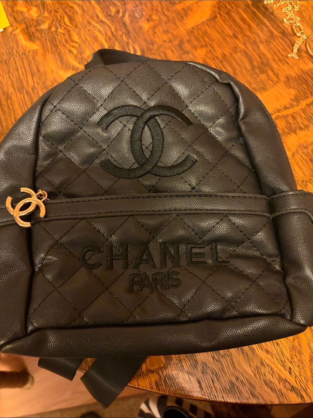 CHANEL Black Quilted Mini Backpack with Gold CC Charm. Gift with purchase.